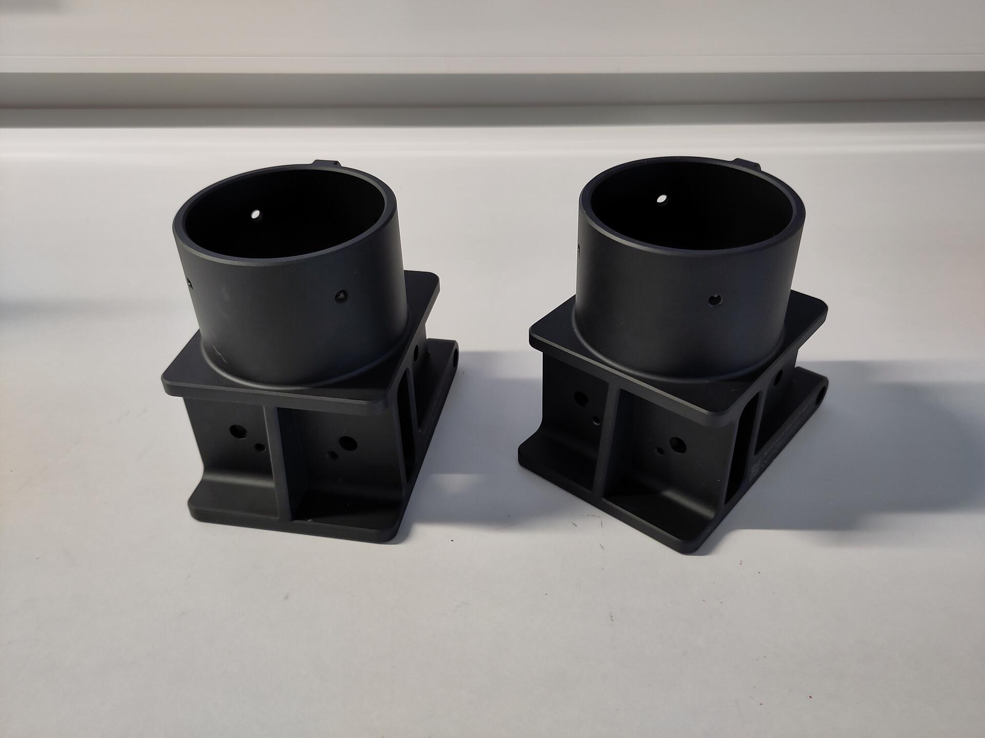 A photo of two Elliot mast bases, black on a white background